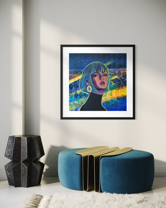 Framed artwork of a contemporary portrait painting inspired by Paris at night with vibrant blue, green and yellow tones on a wall above a modern blue and gold ottoman.