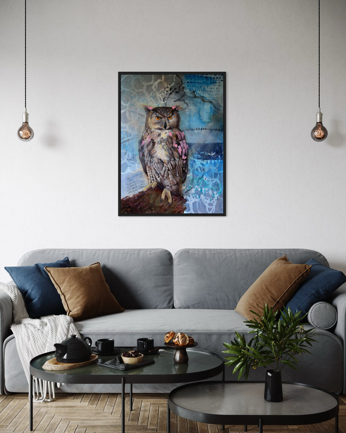 Owl painting with blue abstract background on a wall over grey sofa in living room