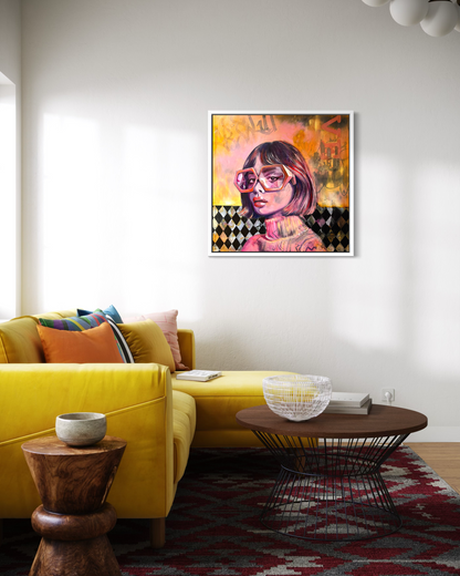 Living room with a yellow sofa, wooden coffee table, and Framed vivid orange and pink portrait artwork of a woman with geometrical shape glasses on the wall.