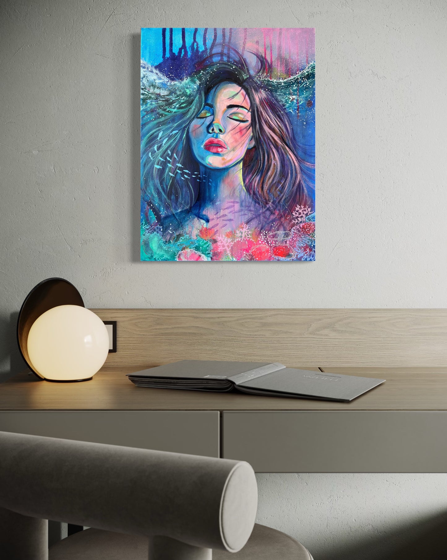 Blue and modern portrait artwork of a woman with long hair in an underwater setting on a wall above a modern study desk.