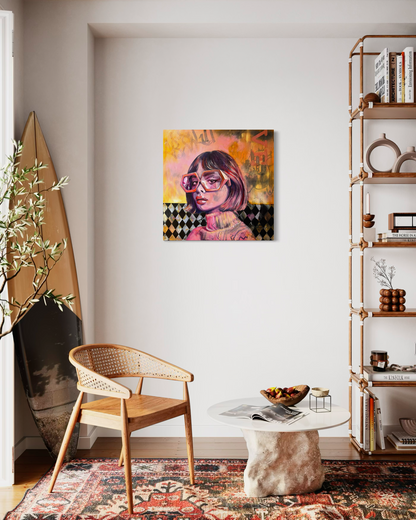 Modern natural coastal interior with a chair, table, and vibrant portrait wall art in a home setting