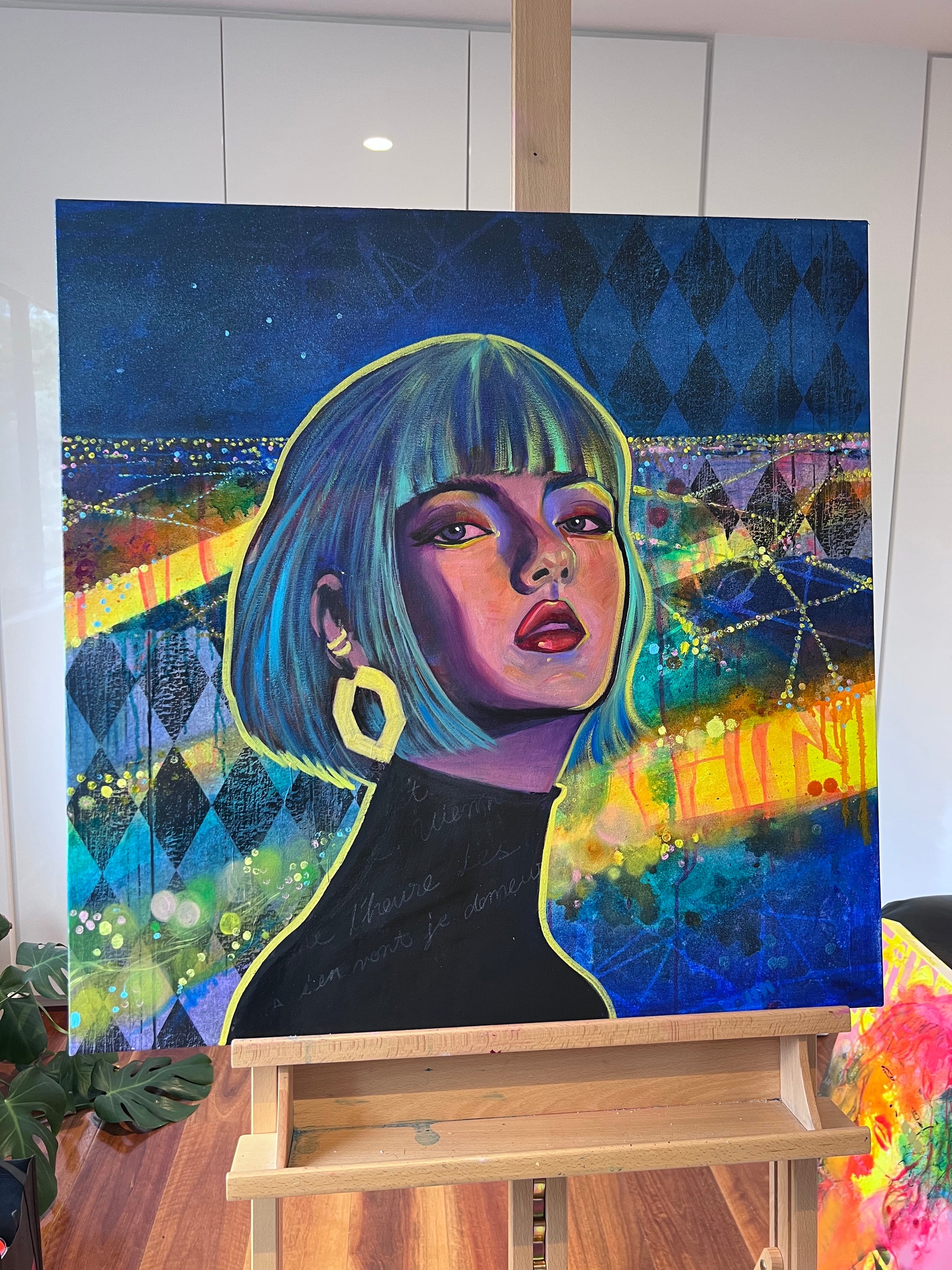 Colorful painting of a woman with a stylized cityscape background on an easel.